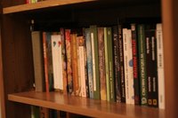 Measure your room to determine the space needed for a bookshelf.