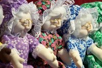 Soft sculpture style granny dolls with their arms outstretched.