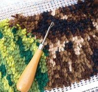 You can make your own rug using the technique of latch-hooking.