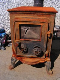 Use an old cast iron wood stove to make a slumping kiln.