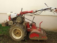 Motorized rotary tillers dig deep within the soil.