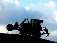 Make a large silhouette of a tractor for a young boys construction party