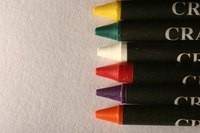 You can use crayons to make a scratchable film for your cards.