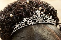 A tiara is presented to the young woman.