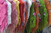 Knitted ponchos on the rack.
