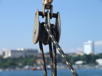 Use a pulley to turn a large tripod into a lifting machine.