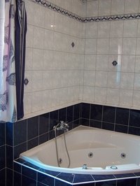 Corner bathtubs make excellent use of space.