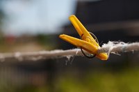 Hang your clothes outside to let the sunshine work on the gas smell.