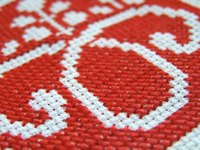 A close-up shot of cross-stitched Aida cloth.