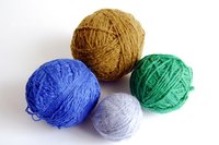Turn yarn into hand knit flat-top hats.