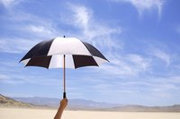 An umbrella can be turned into a humorous hat.