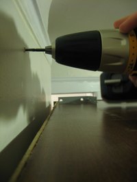 Drill with drill bit in use.
