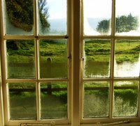 Old window glass is wavy because of its manufacturing process.