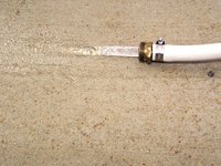 Dampen the garage floor using a water hose.