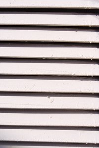 The slats of a jalousie window are operated by a crank.