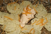 Pour melted queso over chips for a tasty snack.