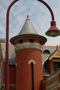 Shingling a conical turret roof requires precise measurements.