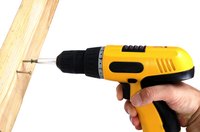 Remove the screws and bore pilot holes for this project using a cordless drill.