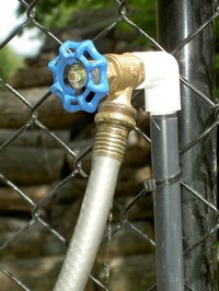 An uncapped outdoor faucet.