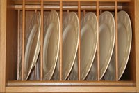 Oak plate rack is used to show plates.
