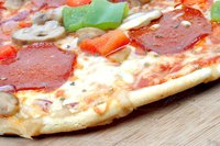 Reheat a frozen pizza in the oven.
