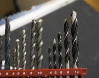 Holes can be made in an acrylic sink with a drill bit.