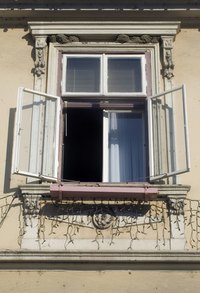 An open window lets cool air escape from a house cooled by central air conditioning.