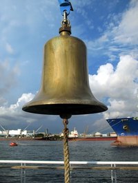 Warm water and soap generally does the trick in restoring bronze bells.