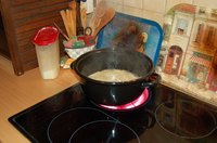 The lid should fit on the inner rim of the lip of the pot.
