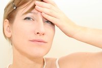 Stress is one of many factors that can cause purple under-eye bags.