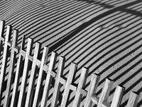 Place a tarp or old sheet under the fence prior to painting to catch the loose paint.