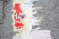 Remove uneven patched areas of concrete by sanding it with an angle grinder.