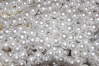 Sewing beads to a wedding dress adds beauty while saving money.