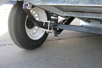 A tow dolly lifts both front wheels of the car off of the ground.