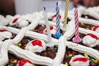 Add a small but festive cake for a man's 90th birthday.