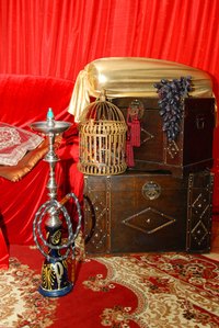 Create an Arabian market atmosphere for the party with authentic Turkish hookahs and Morroccan trunks.
