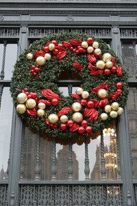 Add ornaments to your Christmas wreath to personalize it.