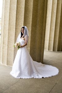 A long train needs to be pulled up so the bride can dance.