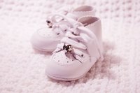 A paper version of a baby shoe makes a good baby shower decoration.