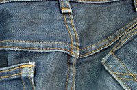 Remove stains from denim, using various home remedies, such as vinegar and rubbing alcohol