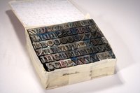 Each metal letter is set left to right and upside down by hand