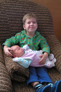 The Boppy surrounds the baby to prevent him from falling.