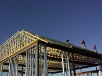 Prefabricated roof trusses replace standard roof framing.