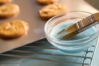Clean nonstick cookie sheets with non-abrasive materials.