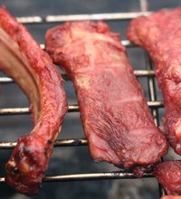 Real barbecued ribs cook slowly in a smoker.