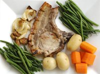 Pork chops pair well with carrots, potatoes and green beans.