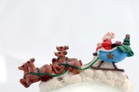 Santa carefully sprinkles each of the reindeer with magic dust.