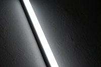 A lens softens the light emitted from fluorescent bulbs.
