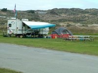 Prolonged moisture exposure causes corrosion holes in RV aluminum siding.
