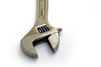 A wrench will secure the bolts on your well cap.